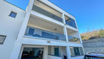 Penthouse + apartment in a new building near the sea with a view, garage- package sale in Dramalj 