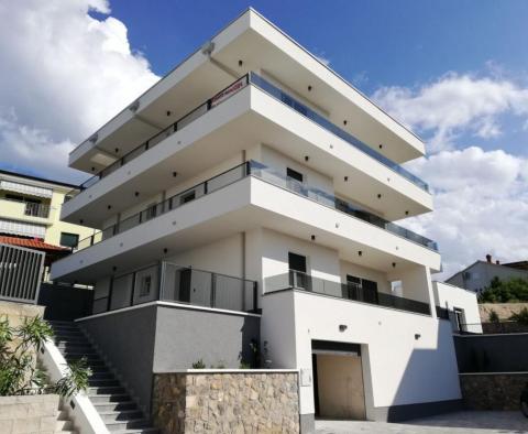 Modern exclusive new building in Kostrena just 300 meters from the sea - ground floor apartment with garden 400m2, apartment 42m2 and garage 100m2 