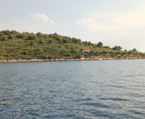 Larger part of a green island within beautiful Kornati archipelago 