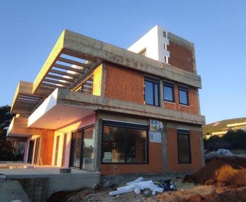 Two modern houses under construction in the second row to the sea in Stara Novalja, Pag 