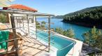 Beautiful newly built waterfront villa with swimming pool and mooring place in a robinson-calm bay on Korcula 